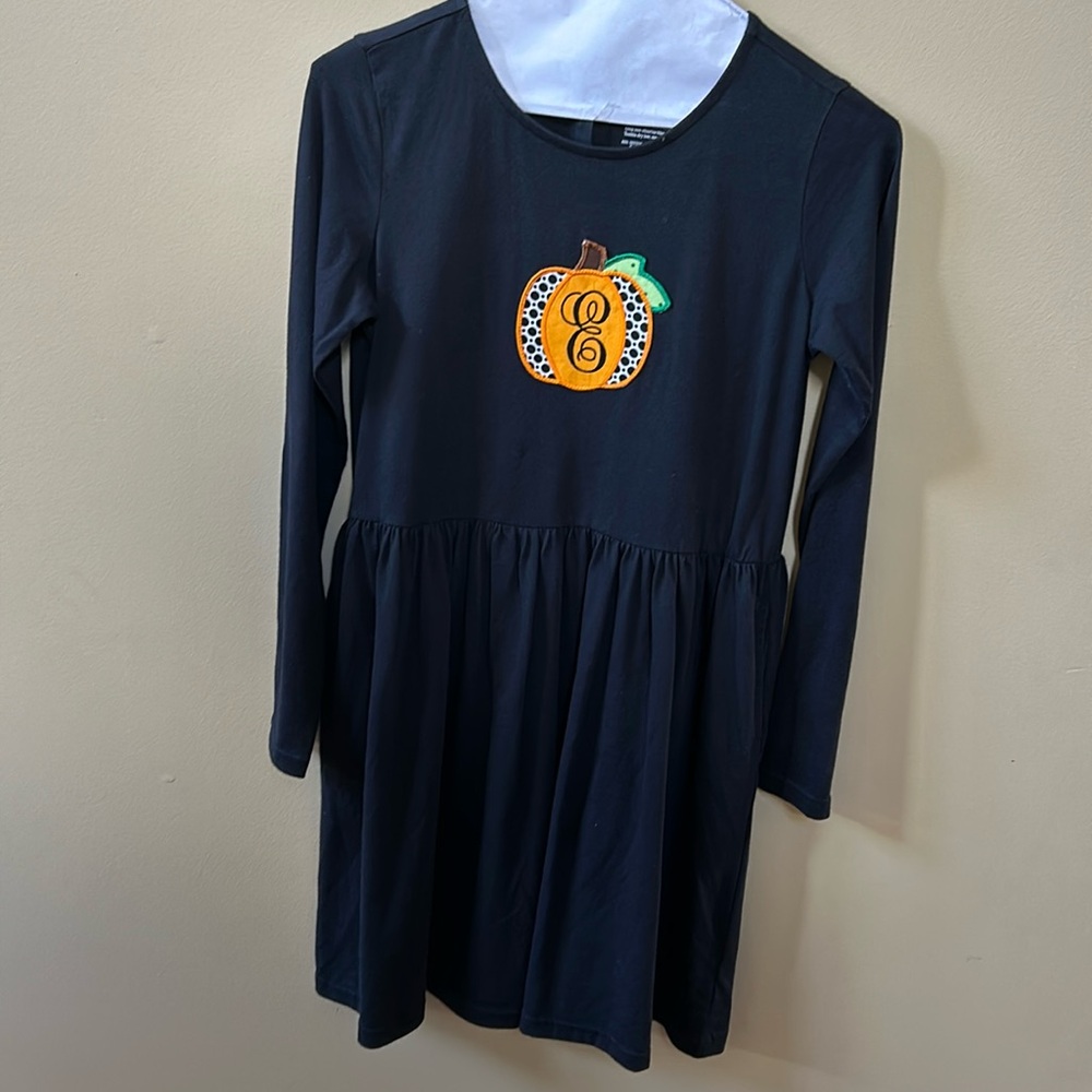 Primary black pocket dress size 14 with E pumpkin patch sewn on. Worn once.